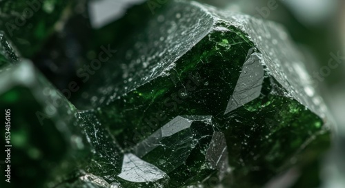 Close-up of deep green, multifaceted crystals with visible facets and textures.  Intricate details show the mineral's natural formation