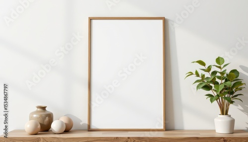 Empty frame on a minimalist table with decorative items and plant.