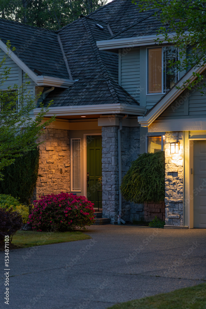 Obraz premium Entrance of luxury house with nice spring blossom landscape at night in Vancouver, Canada, North America. May 2025.