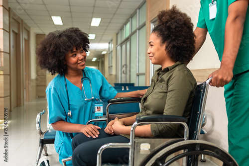 Young  African woman in a wheelchair. Professional young African  doctor  and patient in a nursing home. Assistance, rehabilitation and health care.