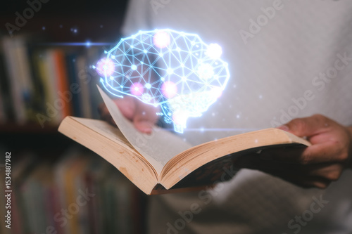 a man holding book and Glowing virtual brain icon in concept of knowledge is power. Self learning education knowledge and business studying concept. Idea of learning online class e-learning at home