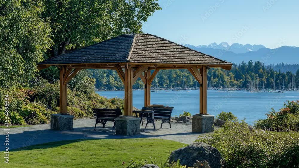 Scenic coastal park gazebo overlooking harbor, featuring mountains beyond