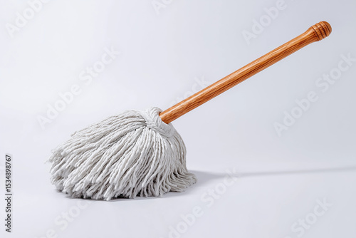 traditional string mop with wooden handle placed upright on bright white background classic and reliable option ideal for janitorial product displays or traditional cleaning tool promotions 