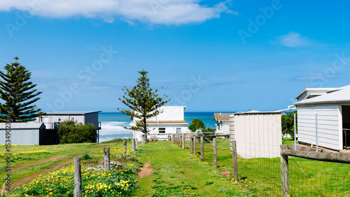 Humble beach shack by the sea, with vacant land behind
