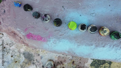 Collection of spray paint nozzles used in creating graffiti.