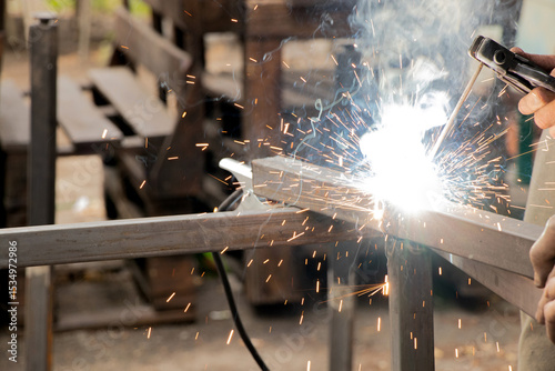 Welding metal parts with sparks and smoke - welder's work process, welding work