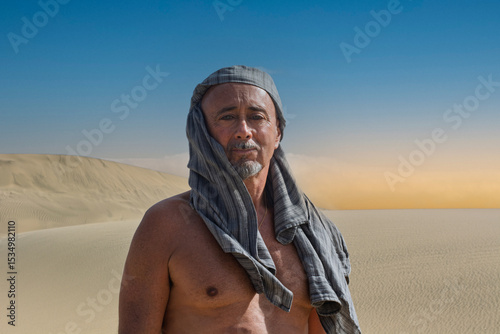 the man with the turban in front of a beautiful sunset In the middle of the desert