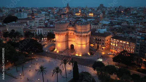 night drone view of Valencia, Torres de Serranos in Valencia at night with illumination, tourism in Valencia, Spain, Spanish travel destination in Catalunya