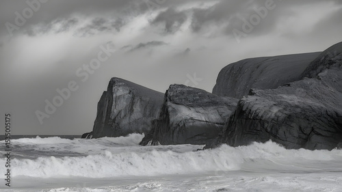 Dramatic black and white seascape showcasing cliffs battling crashing waves under a stormy sky