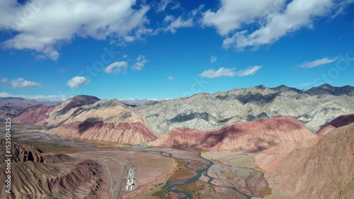 Drone view of Yadan landform near Kashgar in southern Xinjiang, China. High angle view of colorful mountains in sunny autumn day, 4k time lapse landscape footage b roll shot.