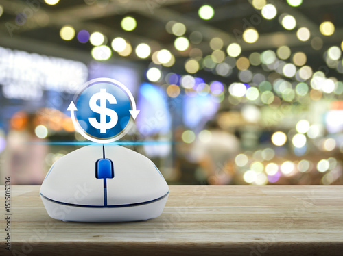Money transfer icon on wireless computer mouse on wooden table over blur light and shadow of shopping mall, Business currency exchange online service concept