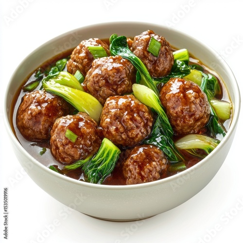 Delicious meatball soup with flavorful broth, tender beef meatballs, fresh green onions, and savory herbs served in a white bowl for hearty meal