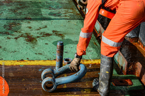 The ship crew is busy with the operations on the main deck. The tanker lifting operations are ongoing and the towing equipment is being organized to get ready for the task