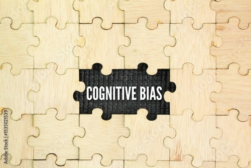 Wooden puzzle with the word Cognitive bias. a systematic thought process caused by the tendency of the human brain to simplify information processing through a filter of personal experience