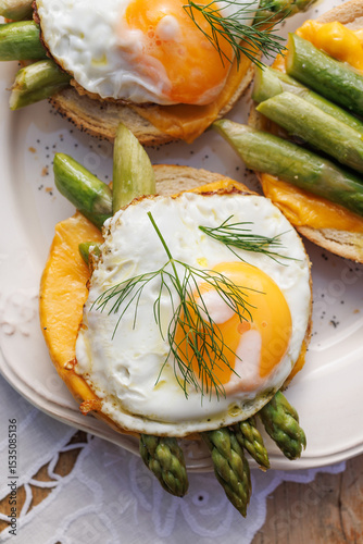 Vegetarian sandwich with fried egg and green asparagus, top view