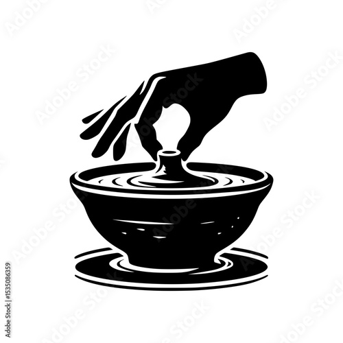 Hand shaping clay on potters wheel