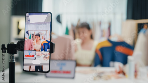 Obraz na plátně Close-up phone screen record Asia lady vlogger look phone camera review sweater new collection live selling online in IG story reel tiktok work at home studio