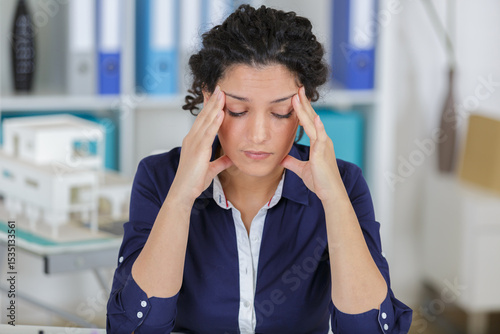 portrait of businesswoman with headache
