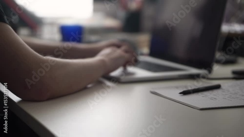 Focused Work – Hand Writing Notes While Working on Laptop
