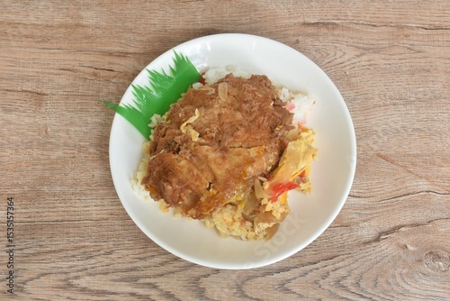 deep fried slice pork with egg or tonkatsu with Japanese pickled vegetable on rice in plate