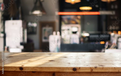 Wooden table with blurred background of cozy café interior and warm lighting.