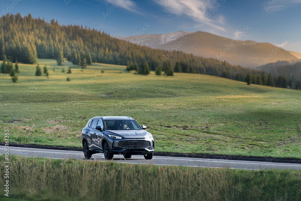 Fototapeta premium Electric Car Glides Down the Road in a Display of Modern Efficiency and Style