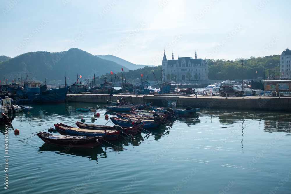 Fototapeta premium Peaceful Harbor with Boats at Sunrise