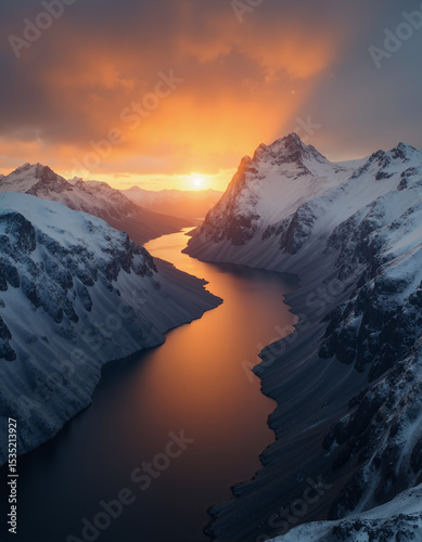 A beautiful northern landscape at sunset, with snow-covered mountains and a lake.