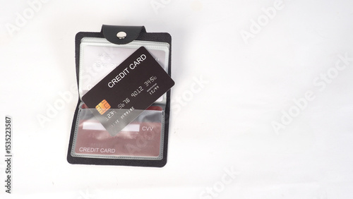 A black credit card holder wallet opened to reveal multiple card slots on white background.