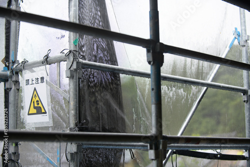 雨に濡れた建築現場の足場