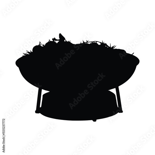 A silhouetted charcoal grill filled with vegetables prepared for a bbq dinner celebration