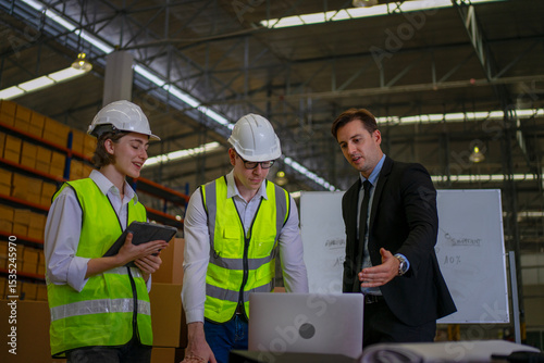 Fotografie Blue collar workers are working and meeting at warehouse.