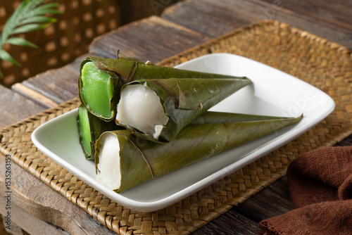 Traditional Malaysian kuih celorot sweet steamed coconut dessert wrapped in coconut leaf cones