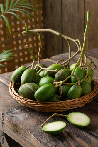 Fresh green kedondong fruits also known as ambarella arranged on a white background