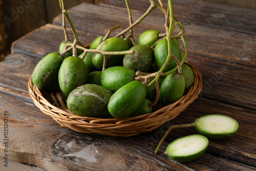 Fresh green kedondong fruits also known as ambarella arranged on a white background
