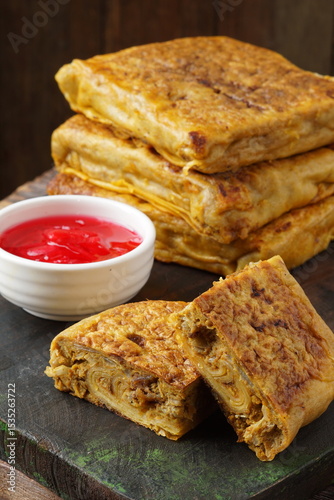 Close up of savory Malaysian murtabak filled with minced beef and chicken served as traditional street food on a plate