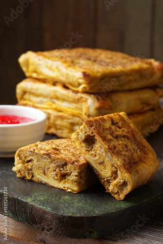 Close up of savory Malaysian murtabak filled with minced beef and chicken served as traditional street food on a plate