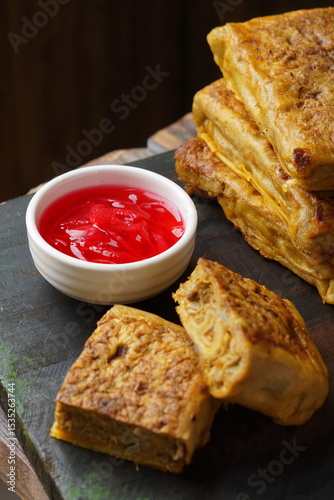 Close up of savory Malaysian murtabak filled with minced beef and chicken served as traditional street food on a plate