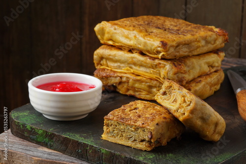 Close up of savory Malaysian murtabak filled with minced beef and chicken served as traditional street food on a plate