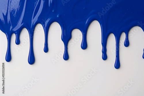 Thick blue paint drips onto a white, uneven surface. The texture appears thick and dense, ideal for product or design backgrounds.