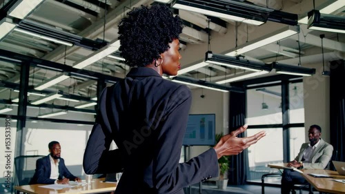 Female boss presenting during team meeting