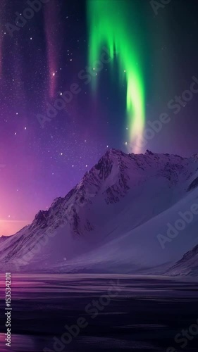 Purple aurora borealis over snowy mountains