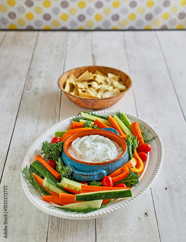 ranch dip with fresh carrots, celery sticks, cherry tomatoes, and broccolini