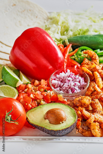spicy shrimp tacos with avocado and bell pepper
