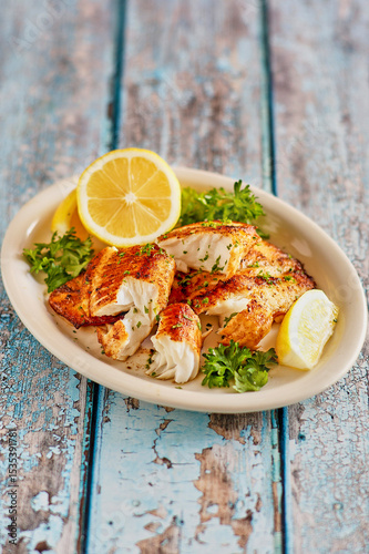 whiskey glazed, cast iron seared fish fillets with fresh lemon and parsley