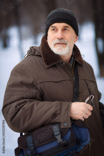 mature man walking down the street on a winter day