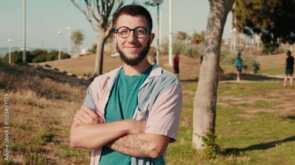 Man Smiling at Camera With Friends in Park