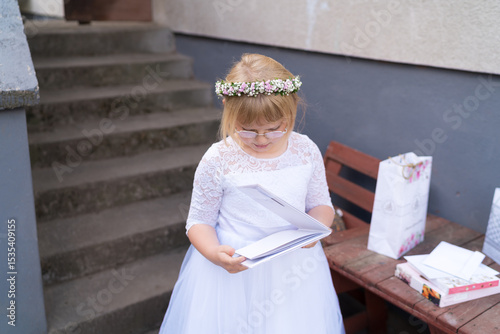 Girl Opening First Communion Gifts