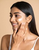 Woman applying face cream skincare routine beauty treatment facial moisturizer
