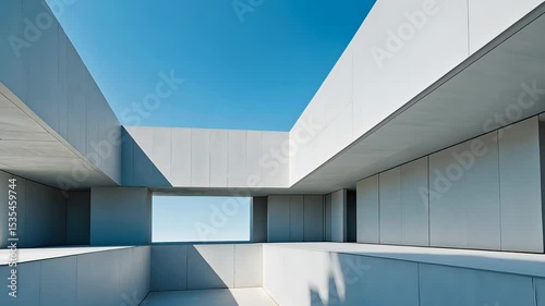 Minimalist concrete architecture with geometric lines and blue sky reflections in a modern open-air space